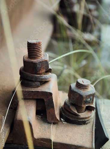 High resolution rusty bolts and screws on abandoned railroad train track