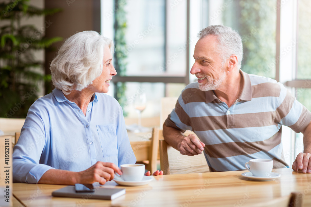 Cheerful couple sitting at the table Cheerful couple sitting at the table