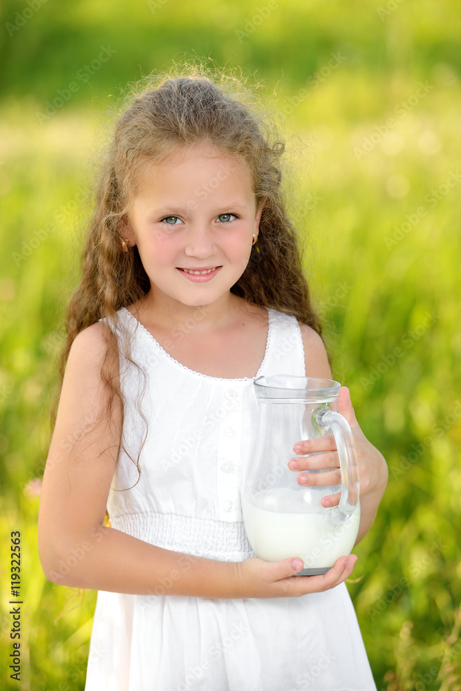 Close up portrait little girl holding pitcher of milk outdoor summer Close up portrait little girl holding pitcher of milk outdoor summer