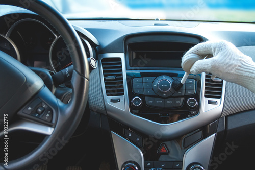 Man wearing gloves to clean the dashboard of the car. Auto Service © perfectlab