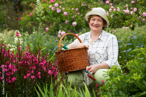 retiree female gardener pink flowers