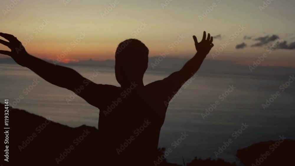 View of male silhouette holding hands up while looking on horizon
View of male silhouette holding hands up while looking on horizon