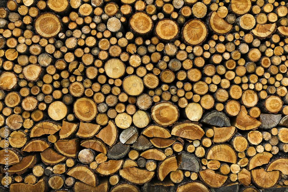 Background of dry chopped firewood logs stacked up on top Background of dry chopped firewood logs stacked up on top