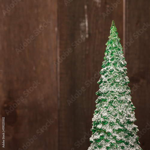 small Christmas tree souvenir on a wooden background