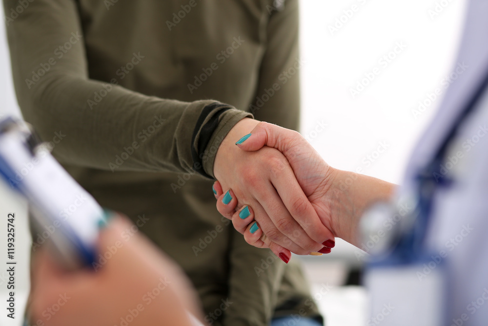 Medicine doctor shake hands as hello with female patient