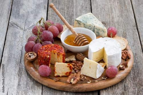 soft cheeses and snacks on a wooden background