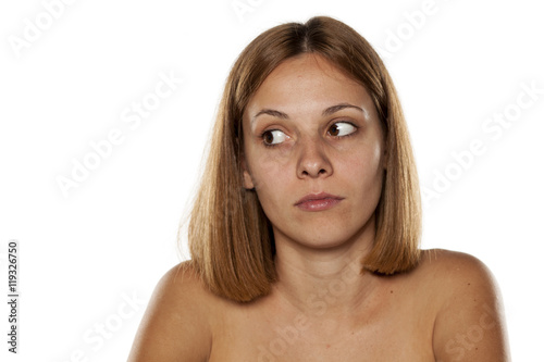 profile of confused young beautiful woman without makeup
