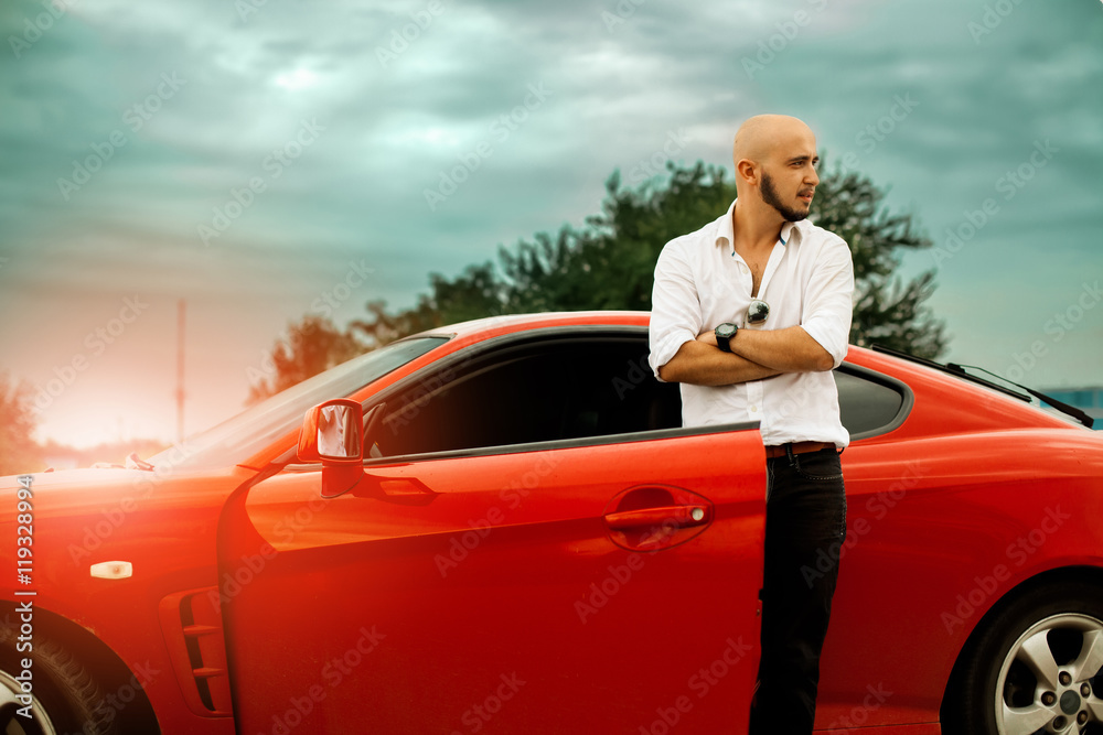 stylish man with red sport car