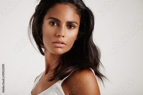 brunette woman watching at camera on a white background