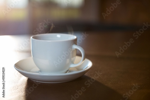 Coffee cup with saucer on a table