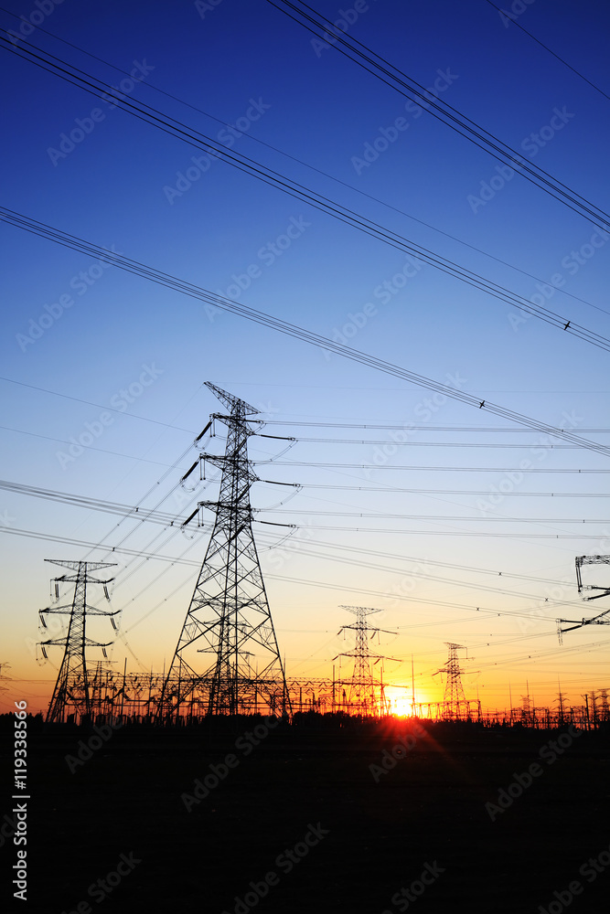 The silhouette of the evening electricity transmission pylon