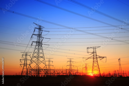 The silhouette of the evening electricity transmission pylon