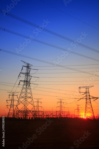 The silhouette of the evening electricity transmission pylon