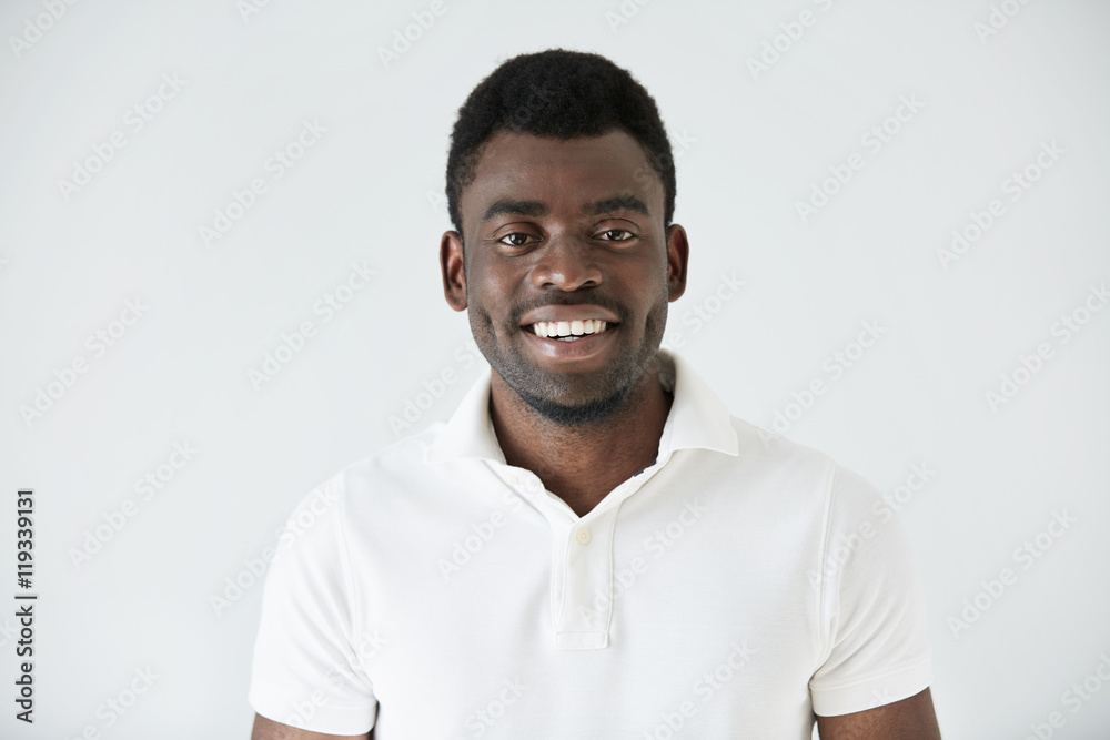 Cropped shot of smiling handsome young casually dressed African man ...