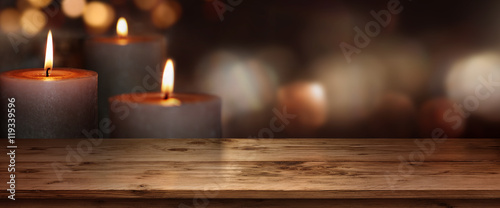 Wooden table with candles background