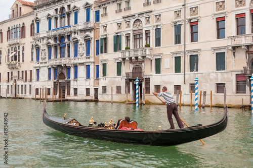 Fototapeta Venetian gondolier on gondola