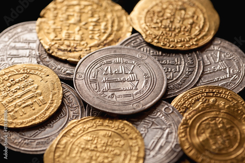 Pile of ancient golden and silver islamic coins photo