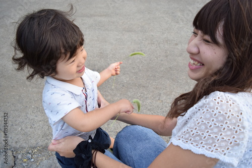 mother and her son are palying outer place