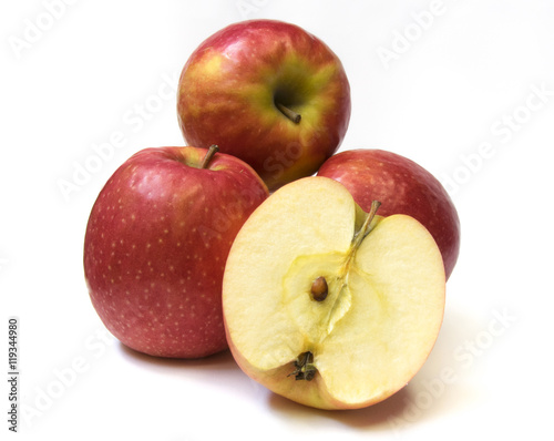 Red apples and slice on a white background.