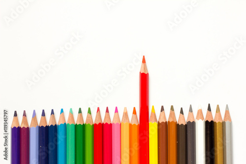 Red color pencil shift from the row of another on white backgrou