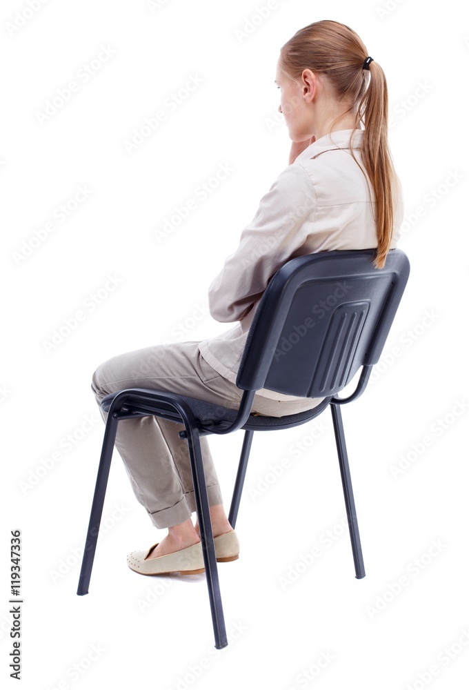 Back View Of Young Beautiful Woman Sitting On Chair. Girl Watching 