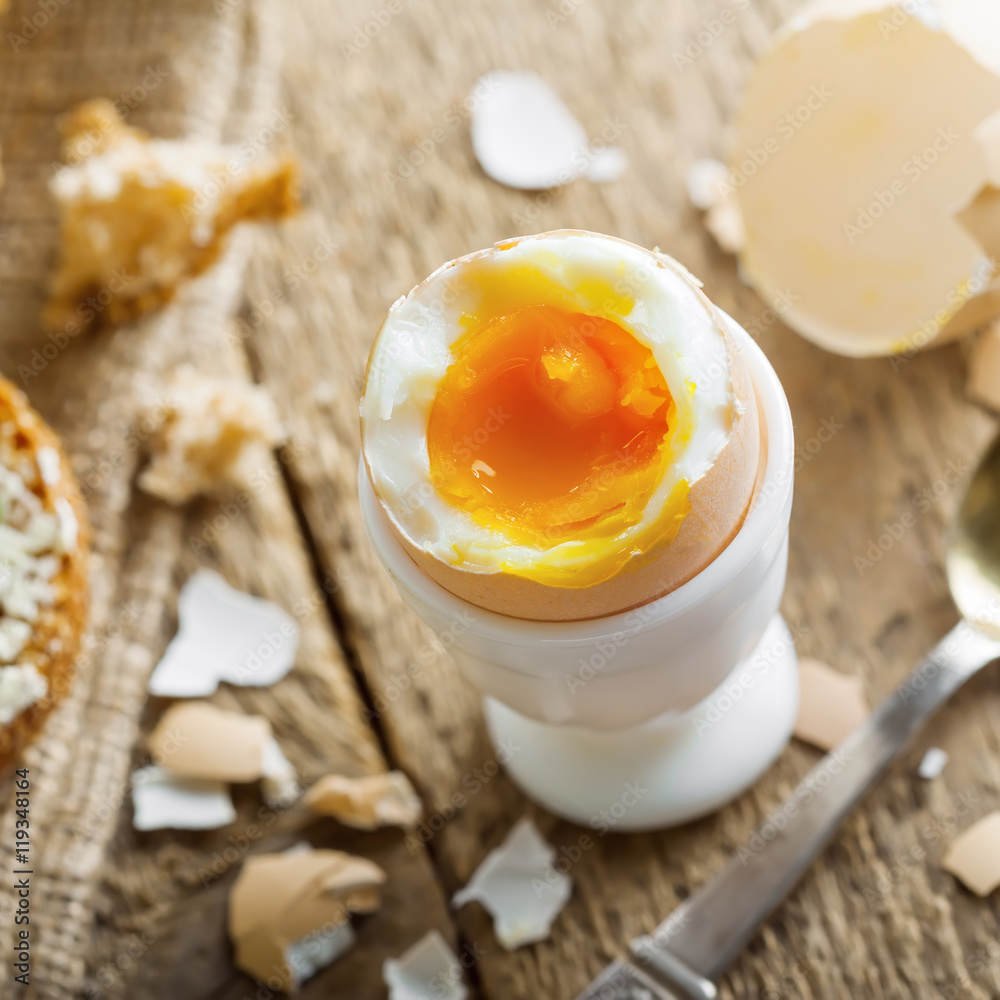 Breakfast with perfect soft boiled egg and sandwich with cheese. Traditional homemade food.