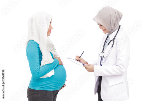 female obstetrician writing down complaints of her patient