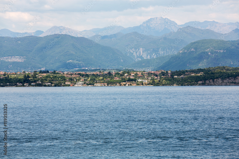 Landscape of the coast of Sirmione peninsula which divides the lower part of Lake Garda. It is a famous vacation place for a long time in northern Italy.