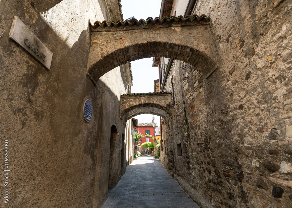Picturesque narrow town street  in Sirmione, Lake Garda Italy.