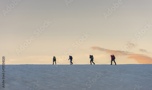 Switzerland, Mountaineers starting early morning from the Bertol Hut photo