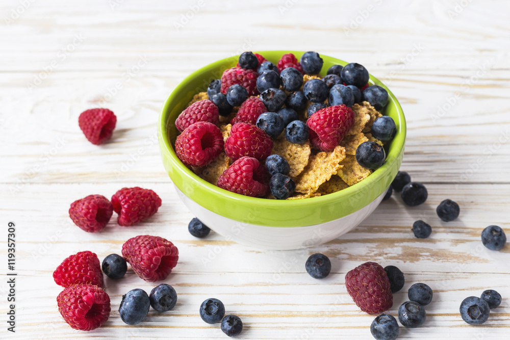 Healthy corn flakes breakfast on the white wooden table Healthy corn flakes breakfast on the white wooden table