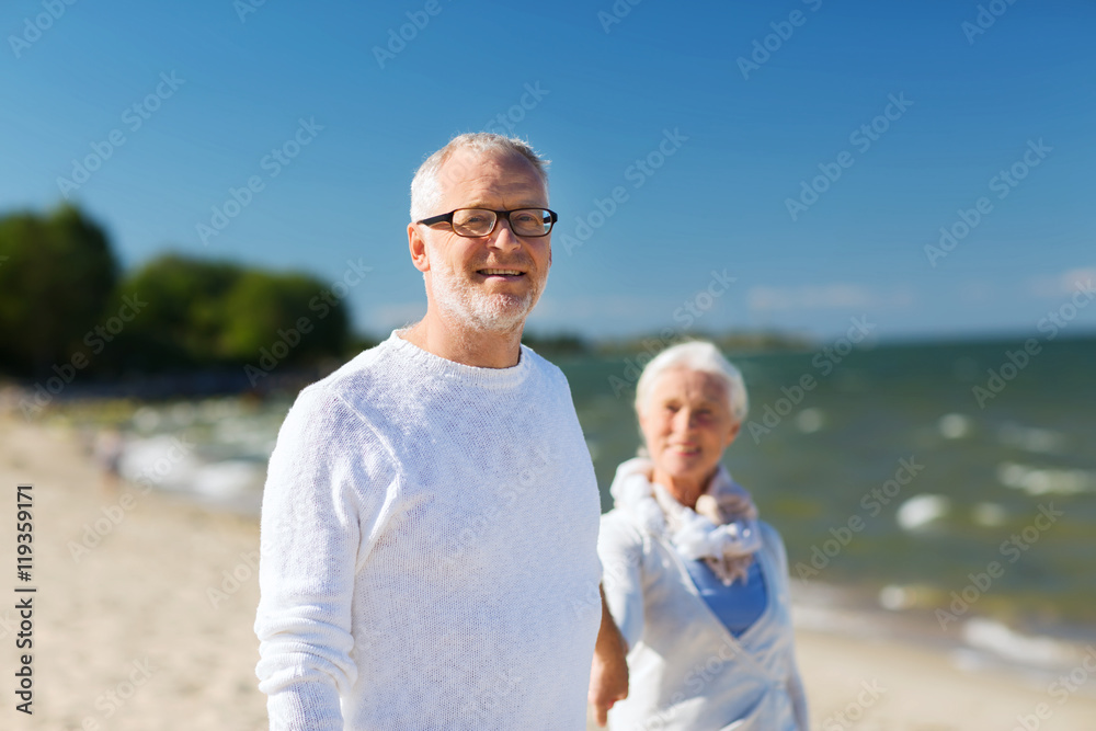 happy senior couple holding hands on summer beach happy senior couple holding hands on summer beach
