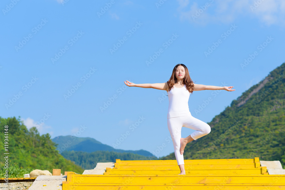 Young woman does yoga exercise outdoors. Young woman does yoga exercise outdoors.