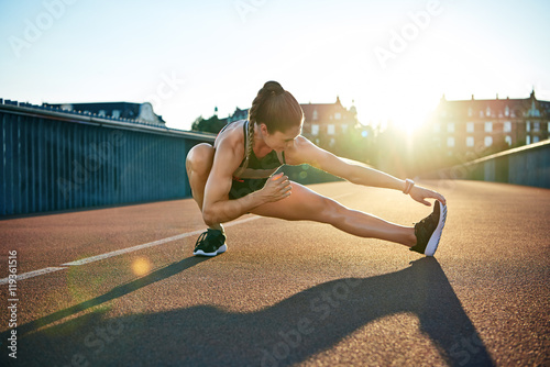 Sun highlights young muscular female athlete photo
