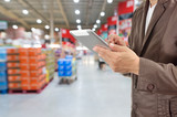 Hand of Businessman, Manger use Mobile Tablet in supermarket