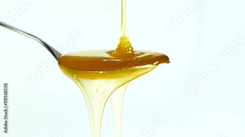 honey dripping on a spoon close-up