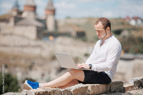Young successful man working on laptop