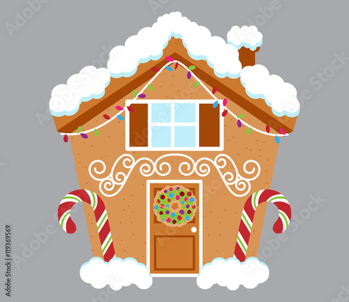 Cute Gingerbread House Covered in Snow and Decorated with Candy and Icing