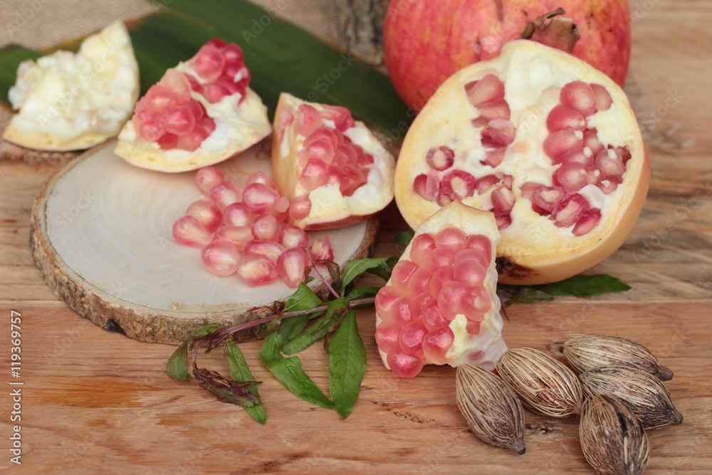 Ripe pomegranate fruit delicious on wood background.