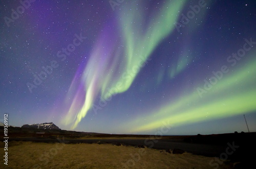 Aurora borealis with mountain background, northern lights in Iceland