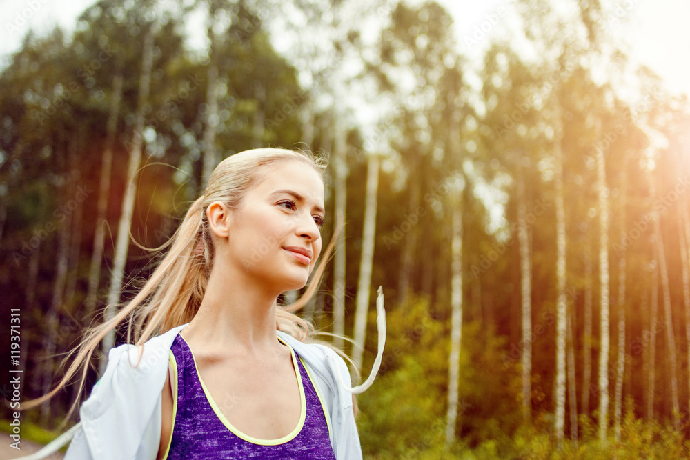 Happy and healthy girl runner on the road, morning jog
