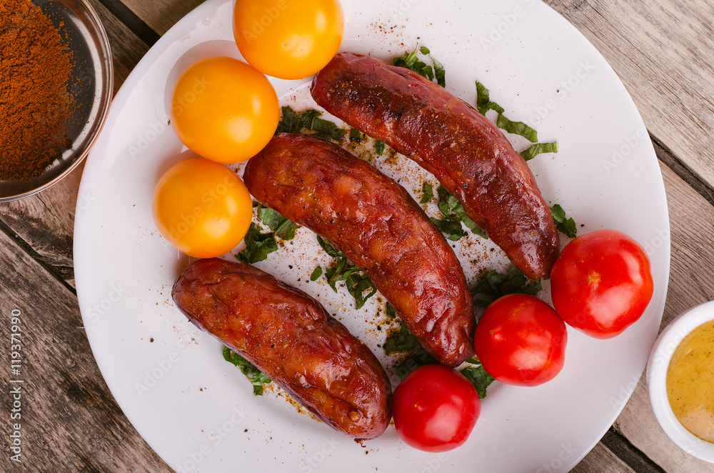 Sausage. Delicious sausages in a plate with ingredients. Salad. Sausage. Delicious sausages in a plate with ingredients. Salad.