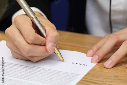 businessman hand signing a contract paper