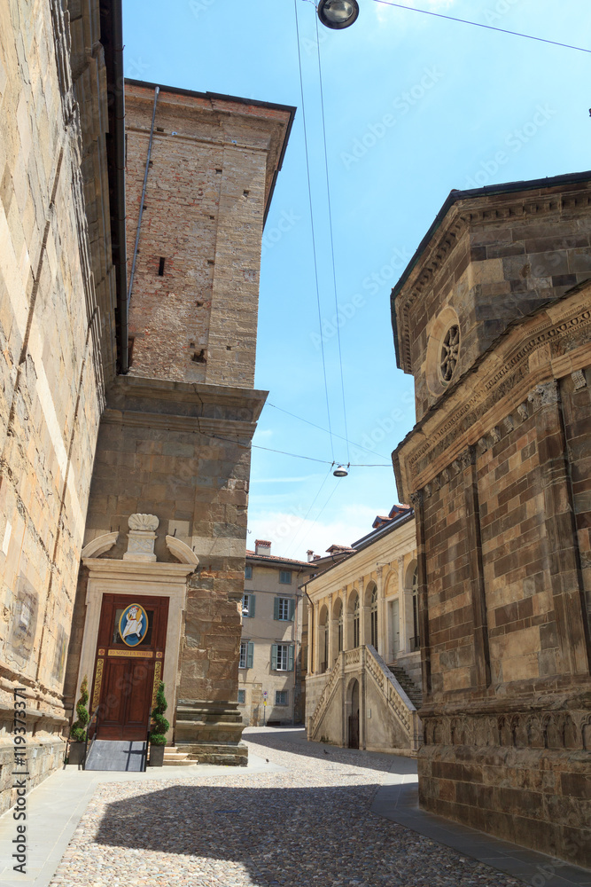 Small alley with Athenaeum of Sciences, Letters and Arts in upper city Citta Alta of Bergamo, Italy