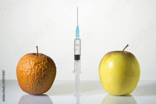 Wrinkled and smooth apples and the syringe