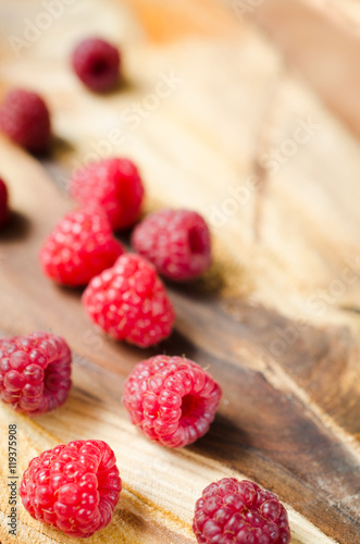 Autumnal concept with raspberry on wooden background