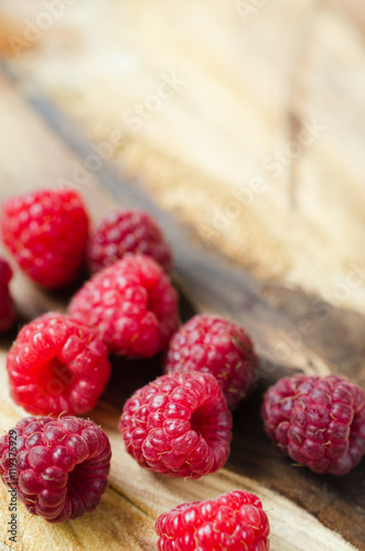 Fresh organic raspberry on wooden background