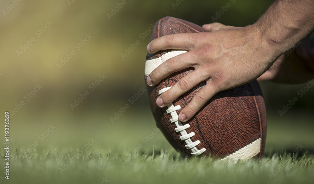 Hiking the football in a football game Stock Photo Adobe Stock