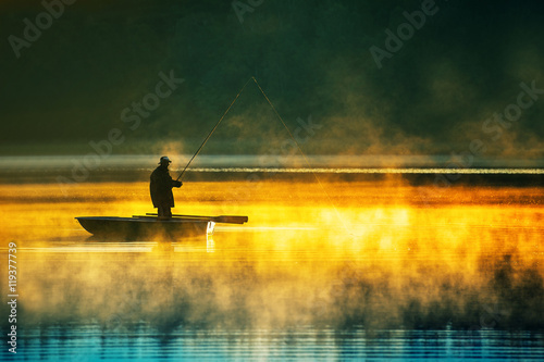 man fishes in the lakes of the Mazury photo