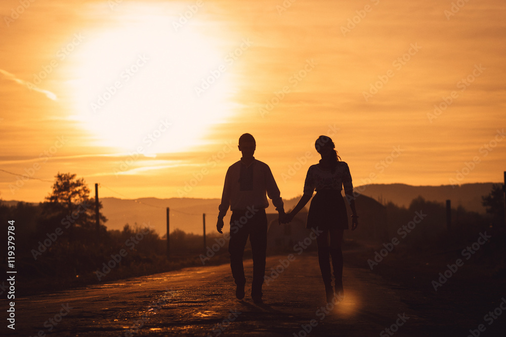 Warm picture of young couple holding each other hands during eve